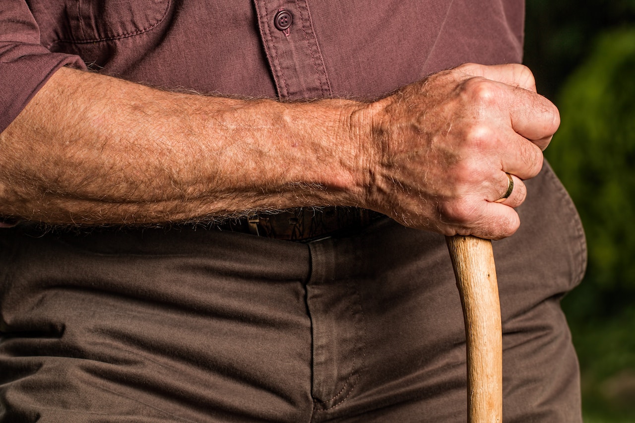 close up of elder's hand holding a cane